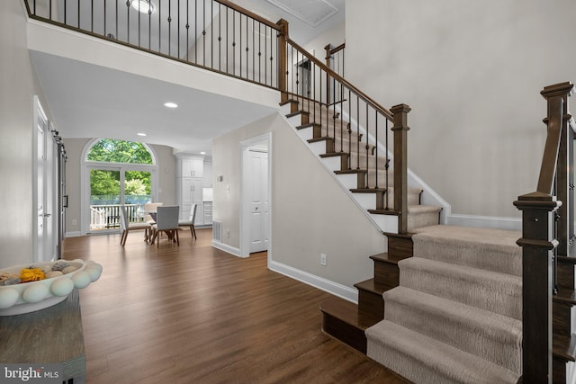 410 Metropolitan Blvd, Pasadena, MD 21122 - stairs featuring baseboards, wood finished floors, a high ceiling, and recessed lighting