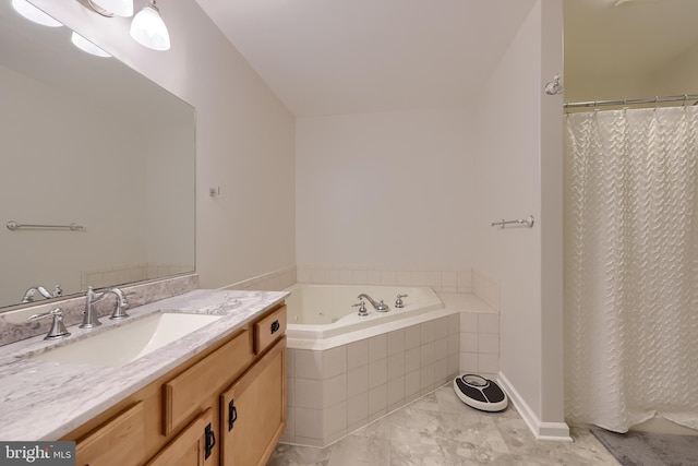 full bathroom featuring vanity, marble finish floors, and a garden tub