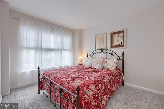 carpeted bedroom with baseboards