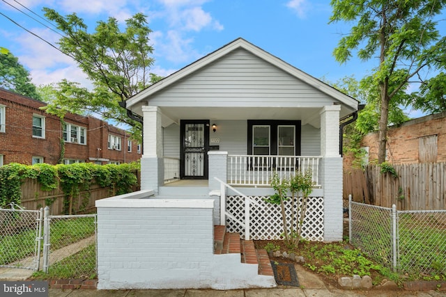 3322 Ely Pl SE, Washington, DC 20019 - shotgun-style home with covered porch and brick siding