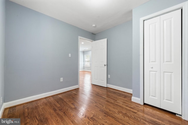 3322 Ely Pl SE, Washington, DC 20019 - unfurnished bedroom with wood finished floors, a closet, and baseboards