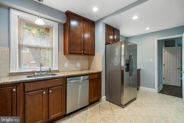 3322 Ely Pl SE, Washington, DC 20019 - kitchen featuring stainless steel appliances, a sink, light stone counters, tasteful backsplash, and recessed lighting