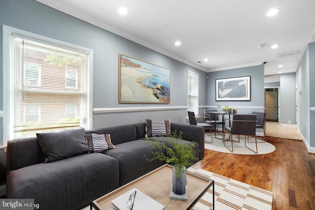 3322 Ely Pl SE, Washington, DC 20019 - living area featuring ornamental molding, healthy amount of natural light, wood finished floors, recessed lighting, and baseboards