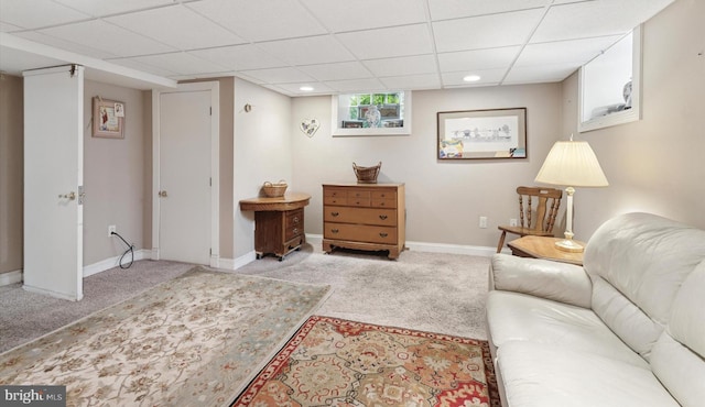 carpeted living room with a drop ceiling, baseboards, and recessed lighting