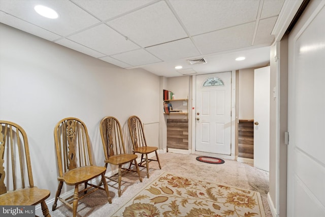 living area featuring carpet flooring, baseboards, a paneled ceiling, recessed lighting, and stairs