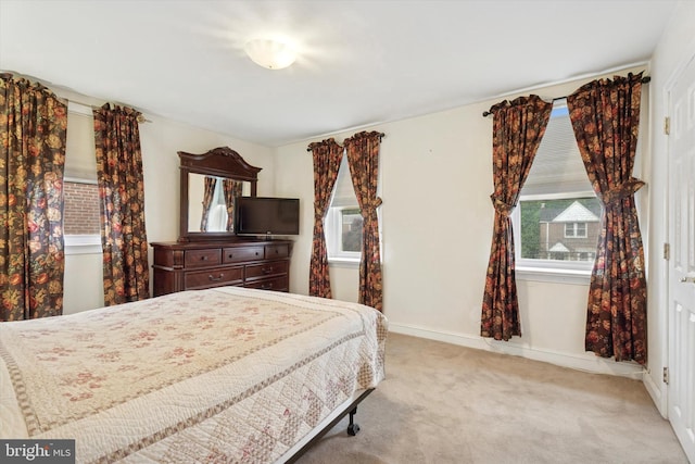 carpeted bedroom with baseboards