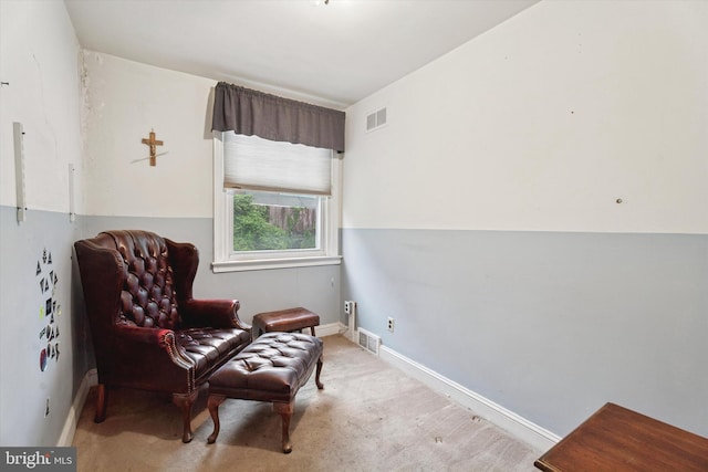 sitting room featuring carpet flooring and baseboards