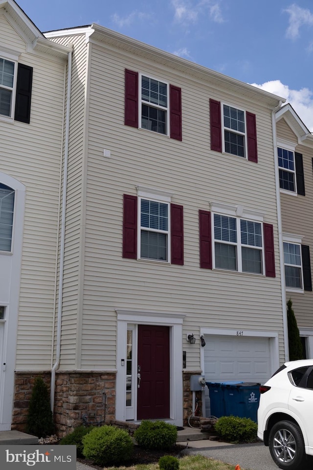 847 Lissicasey Loop, Middletown, DE 19709 - townhome / multi-family property with stone siding and an attached garage