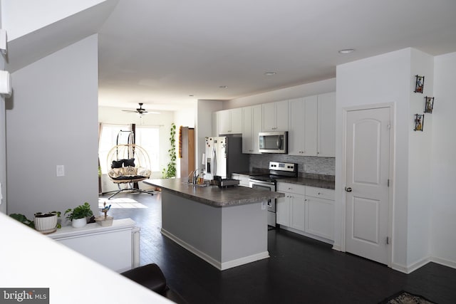 847 Lissicasey Loop, Middletown, DE 19709 - kitchen featuring stainless steel appliances, dark countertops, white cabinets, dark wood-type flooring, and recessed lighting