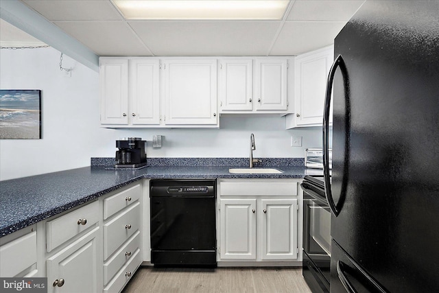 6007 Atlantic Ave Unit 207, Ocean City, MD 21842 - kitchen featuring black appliances, a drop ceiling, white cabinets, a sink, and light wood-style floors