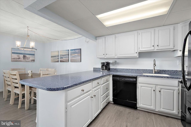 6007 Atlantic Ave Unit 207, Ocean City, MD 21842 - kitchen featuring dishwasher, a sink, a peninsula, light wood-style flooring, and dark countertops