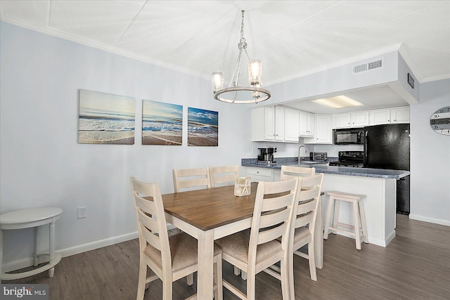 6007 Atlantic Ave Unit 207, Ocean City, MD 21842 - dining space featuring a chandelier, wood finished floors, baseboards, and crown molding