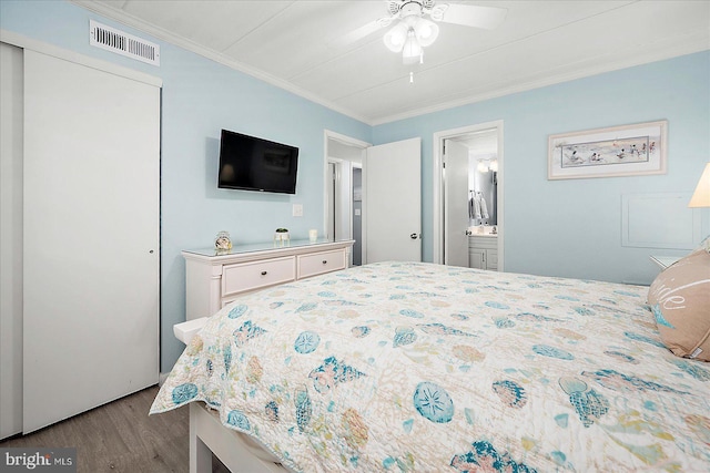6007 Atlantic Ave Unit 207, Ocean City, MD 21842 - bedroom featuring wood finished floors, ornamental molding, a closet, and ensuite bathroom