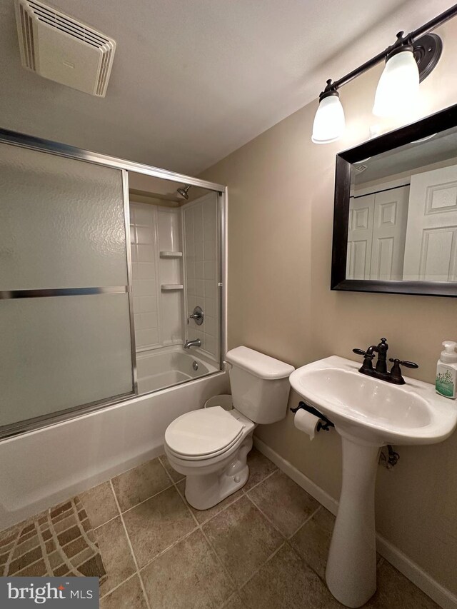 full bathroom with toilet, baseboards, combined bath / shower with glass door, and tile patterned floors