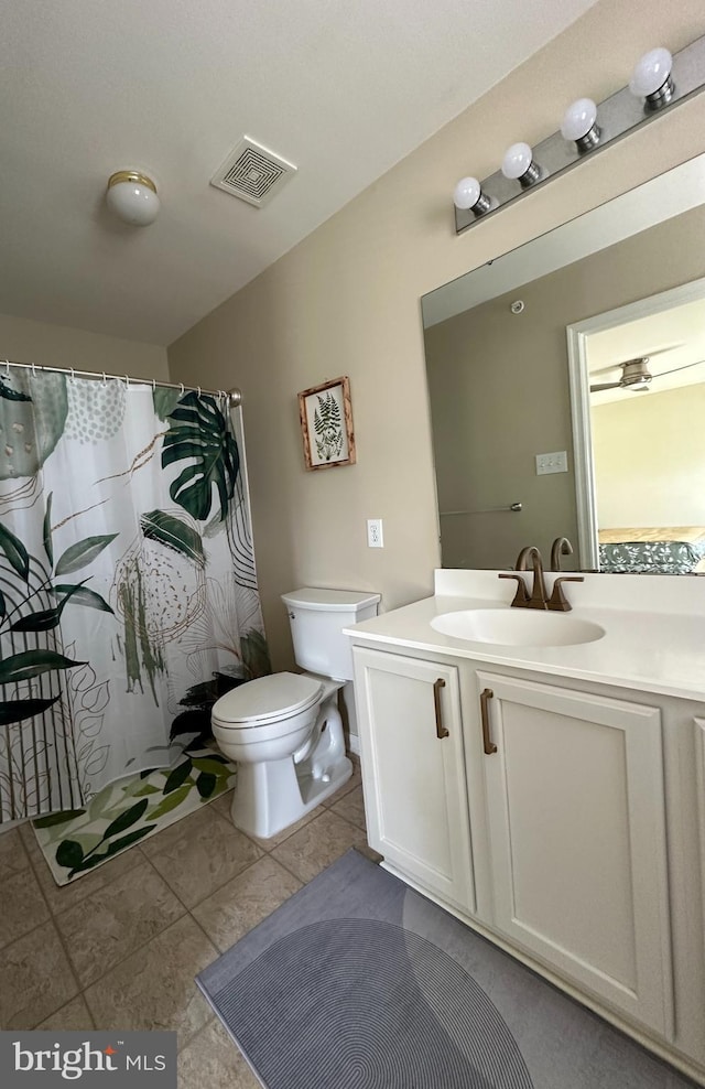 bathroom featuring vanity, toilet, tile patterned floors, and a shower with shower curtain