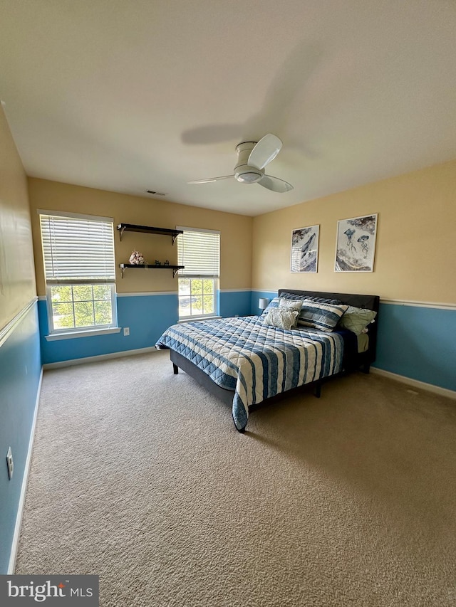 bedroom with multiple windows, carpet floors, baseboards, and ceiling fan