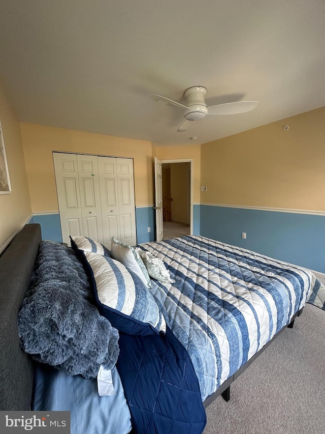 carpeted bedroom featuring a closet and ceiling fan