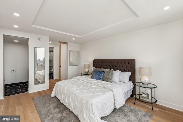 604 S Washington Sq Unit 2917, Philadelphia, PA 19106 - bedroom featuring a raised ceiling, wood finished floors, recessed lighting, and baseboards