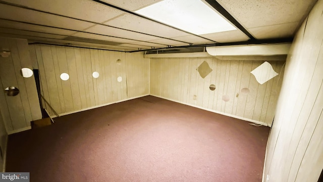 3726 5th St, Baltimore, MD 21225 - finished below grade area featuring dark carpet, wooden walls, and baseboards