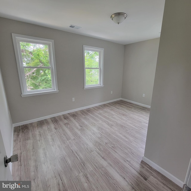 3608 Upshur St, Brentwood, MD 20722 - empty room with healthy amount of natural light, wood finished floors, and baseboards