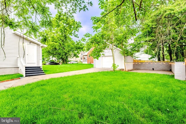 3608 Upshur St, Brentwood, MD 20722 - view of green lawn with an outbuilding, entry steps, and driveway