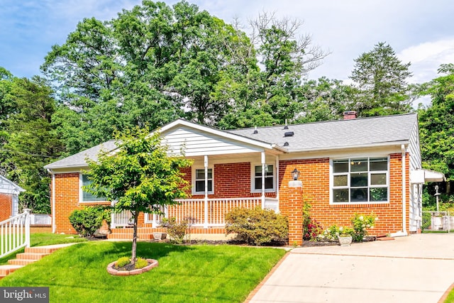 15415 Michigan Rd, Woodbridge, VA 22191 - view of front facade featuring covered porch, brick siding, a front yard, and a shingled roof
