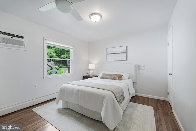 15415 Michigan Rd, Woodbridge, VA 22191 - bedroom with an AC wall unit, a baseboard radiator, wood finished floors, and baseboards