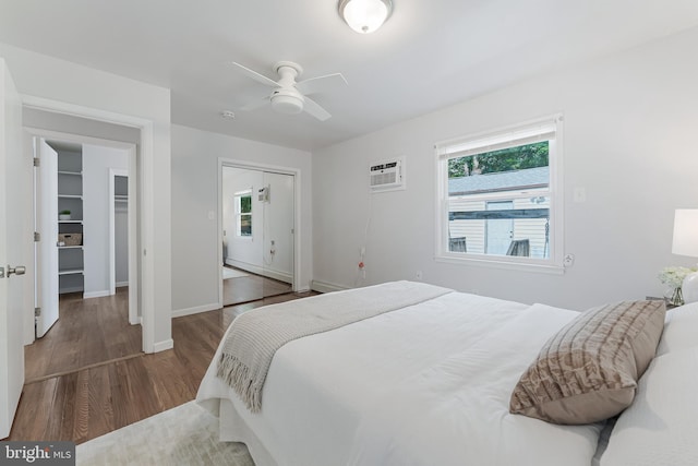 15415 Michigan Rd, Woodbridge, VA 22191 - bedroom featuring wood finished floors, baseboards, a wall mounted AC, a closet, and ceiling fan