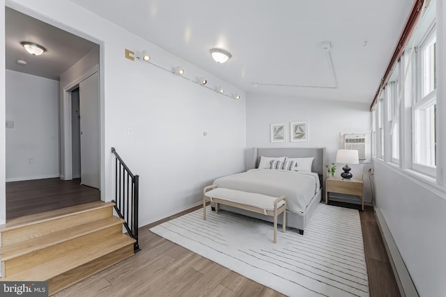 15415 Michigan Rd, Woodbridge, VA 22191 - bedroom featuring wood finished floors, a wall unit AC, and baseboards
