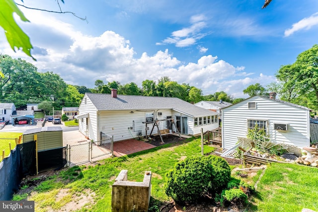 15415 Michigan Rd, Woodbridge, VA 22191 - back of house featuring a gate, a chimney, a deck, and roof with shingles