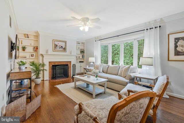1153 Randolph Rd, Mclean, VA 22101 - living room featuring ceiling fan, crown molding, built in features, wood finished floors, and a fireplace