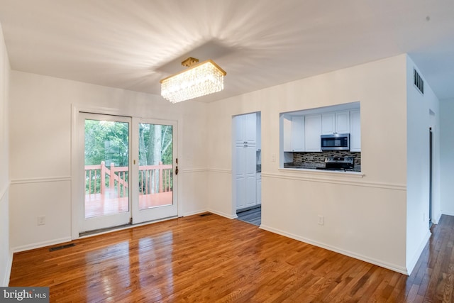 5 Wood Oak, Nottingham, MD 21236 - unfurnished room featuring wood finished floors and a chandelier