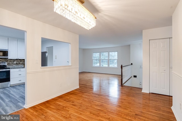 5 Wood Oak, Nottingham, MD 21236 - empty room featuring light wood-style flooring and a chandelier
