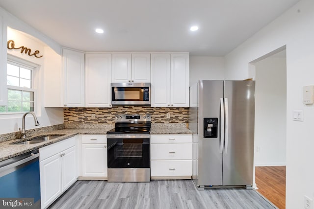 5 Wood Oak, Nottingham, MD 21236 - kitchen featuring appliances with stainless steel finishes, light wood-style flooring, light stone counters, white cabinets, and recessed lighting