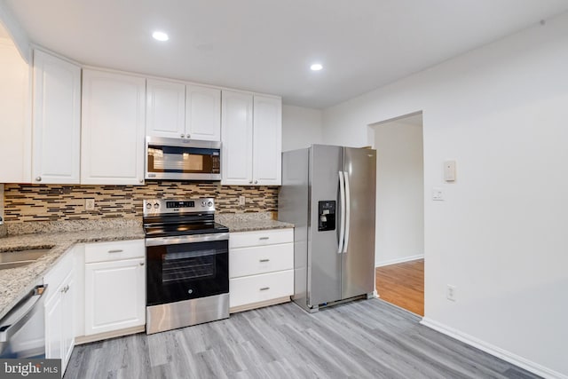 5 Wood Oak, Nottingham, MD 21236 - kitchen featuring stainless steel appliances, light wood finished floors, backsplash, light stone counters, and white cabinets
