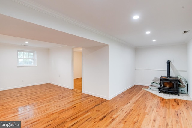 5 Wood Oak, Nottingham, MD 21236 - unfurnished living room with a wood stove, light wood-style floors, ornamental molding, and recessed lighting