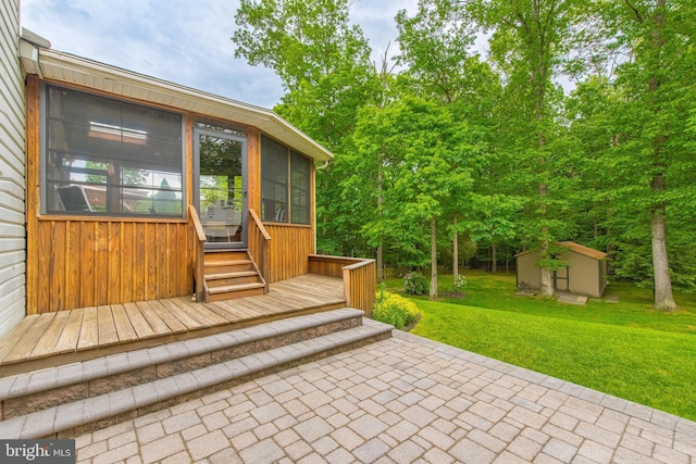 view of patio with a sunroom, an outbuilding, and a storage unit