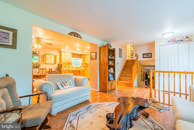 living area with light wood-style floors and stairs