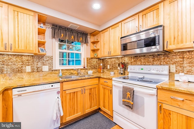 kitchen with white appliances, open shelves, a sink, backsplash, and light stone countertops