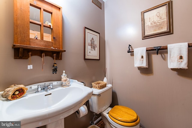 half bathroom with a sink and toilet