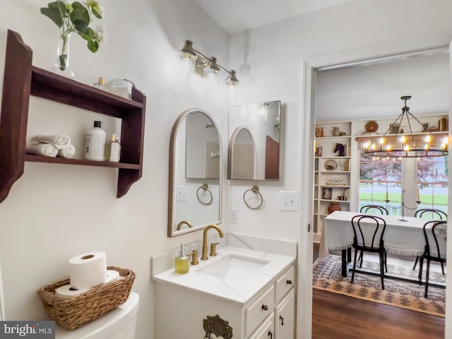 11600 Saddleback Dr, Fredericksburg, VA 22407 - bathroom featuring a chandelier, vanity, wood finished floors, and toilet