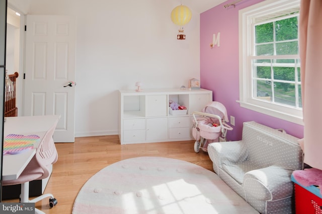 bedroom with light wood finished floors and baseboards