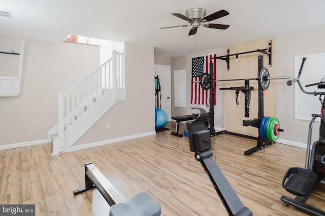 exercise area featuring wood finished floors, ceiling fan, and baseboards