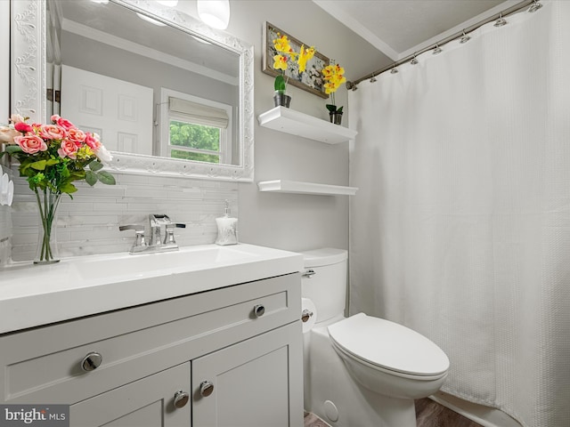 bathroom with tasteful backsplash, toilet, crown molding, vanity, and curtained shower