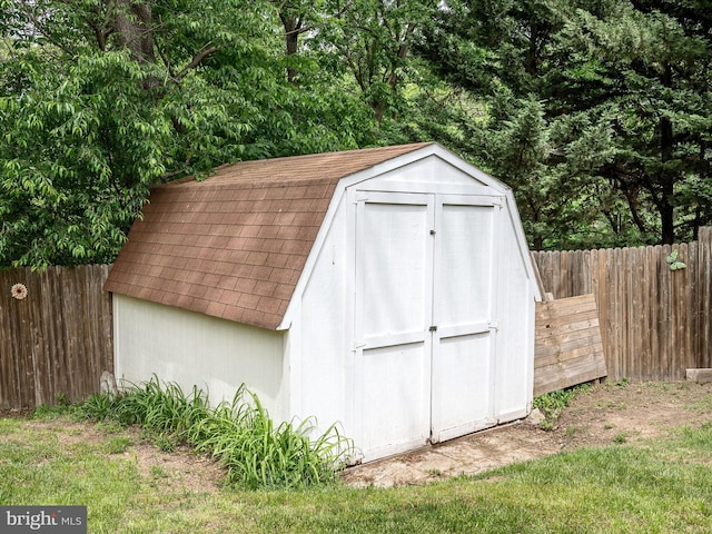 view of shed featuring fence