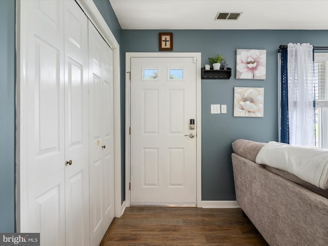 entrance foyer featuring dark wood-style flooring and baseboards