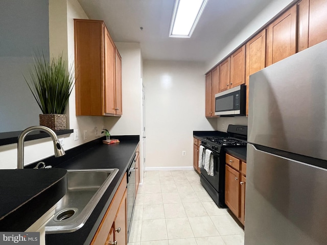 4862 Eisenhower Ave Unit 269, Alexandria, VA 22304 - kitchen with appliances with stainless steel finishes, a sink, dark countertops, and brown cabinetry