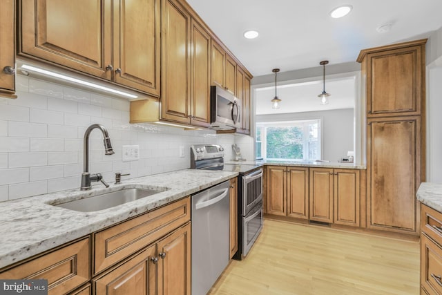 2901 N Rochester St, Arlington, VA 22213 - kitchen featuring stainless steel appliances, a sink, brown cabinets, and recessed lighting