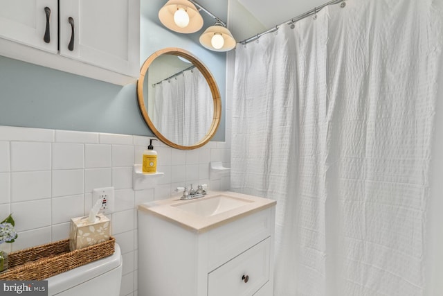2901 N Rochester St, Arlington, VA 22213 - bathroom featuring vanity, toilet, tile walls, curtained shower, and a wainscoted wall