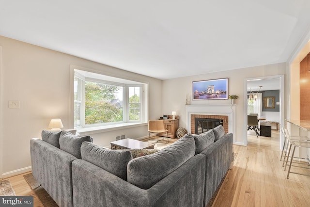 2901 N Rochester St, Arlington, VA 22213 - living area with light wood-type flooring, healthy amount of natural light, a fireplace, and baseboards